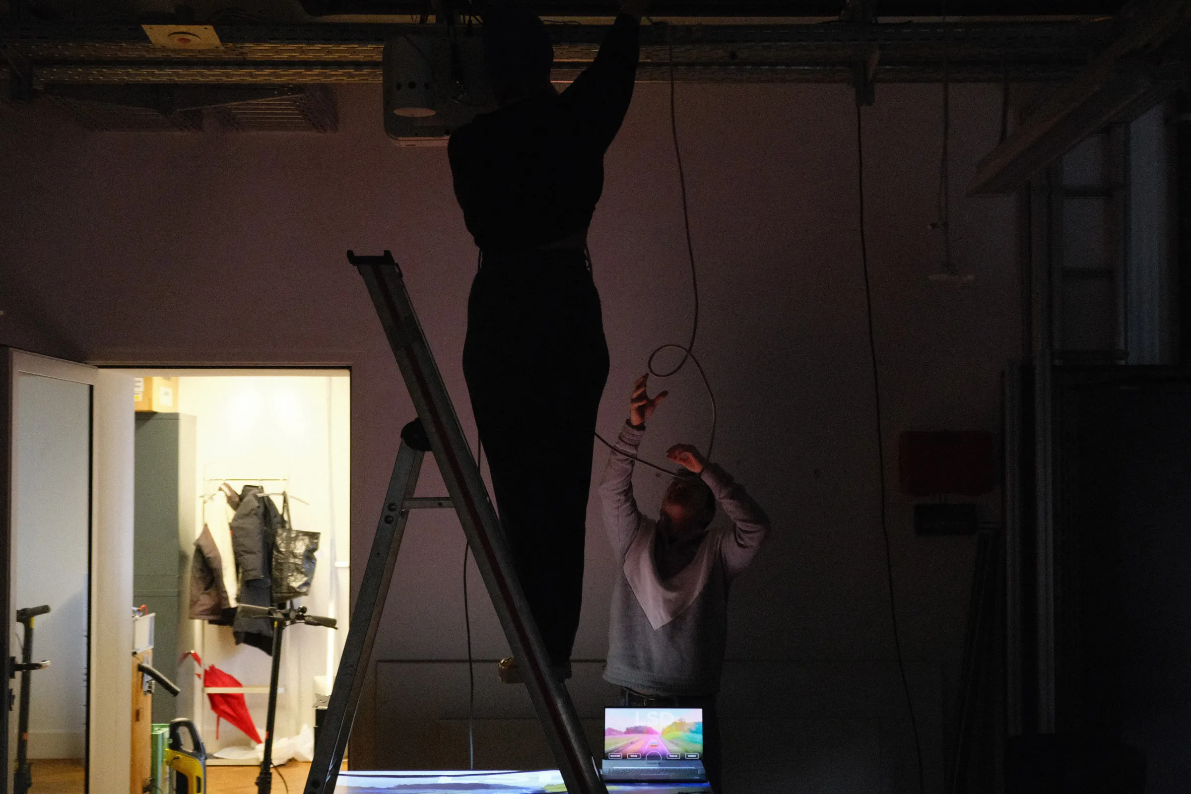 Ceiling installation setup showing the mounted projector and directional speaker unit above the table.