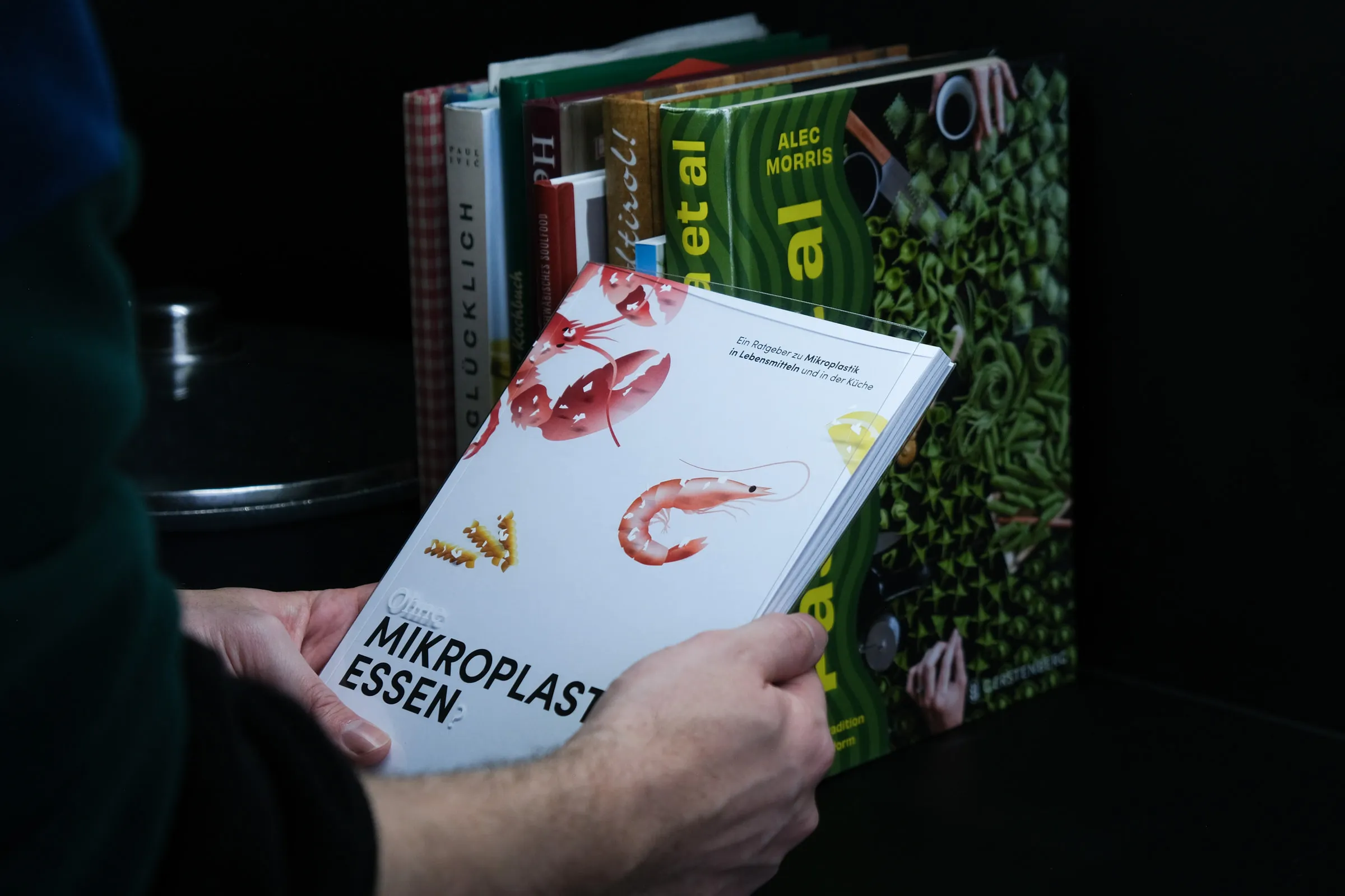 Book cover held up to the camera by a man