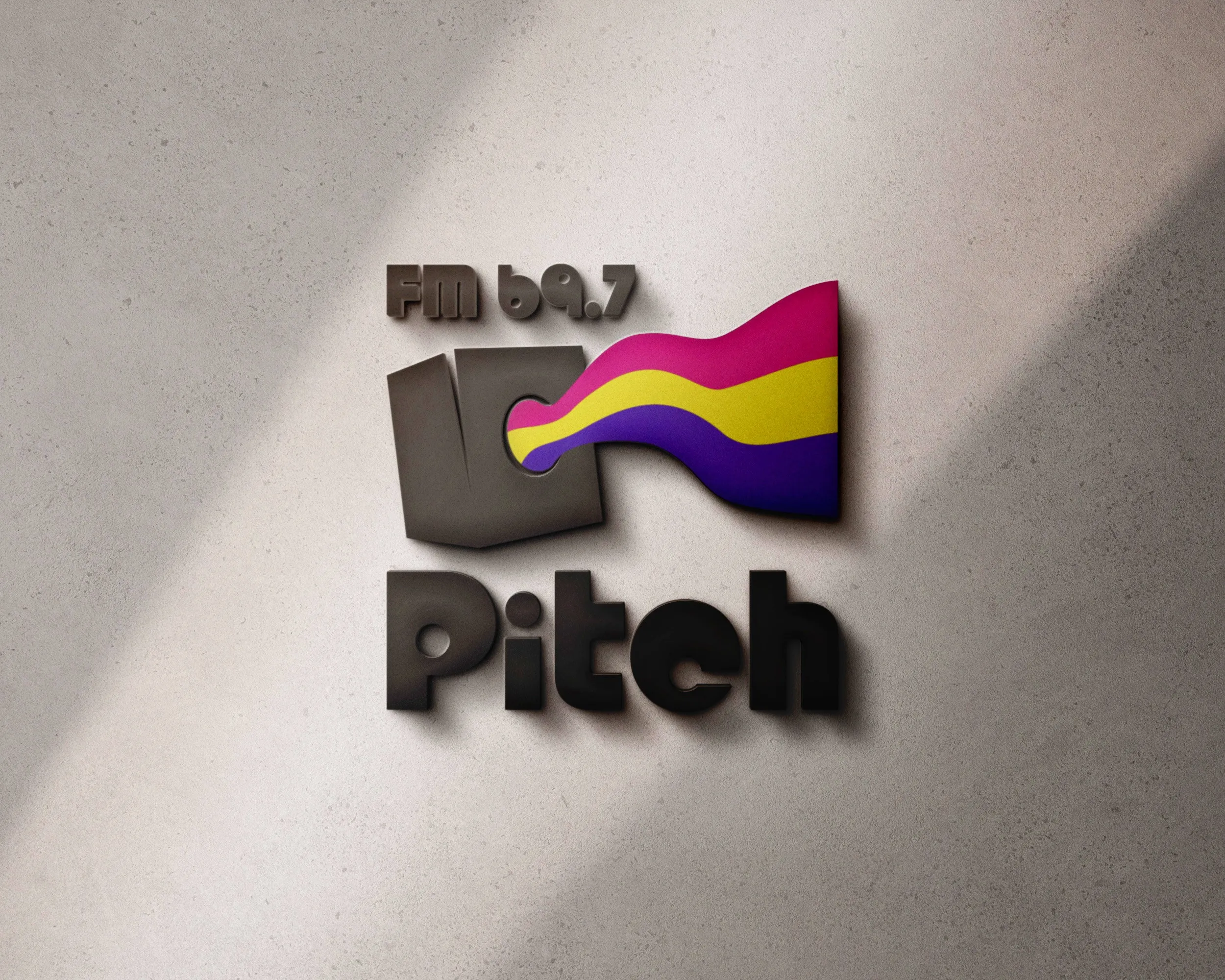 The 'Pitch FM 69.7' logo as wall signage: a dark square from which a pink, yellow and violet wave band emerges.